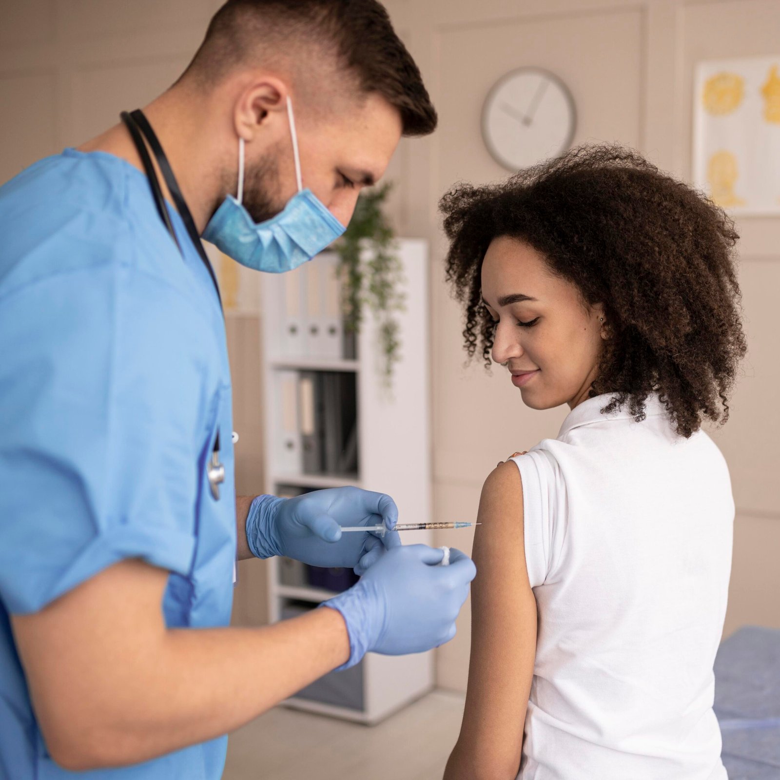 doctor-vaccinating-patient-clinic